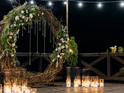 huge-decorative-circle-made-willow-greenery-pale-orange-roses-with-burning-candles